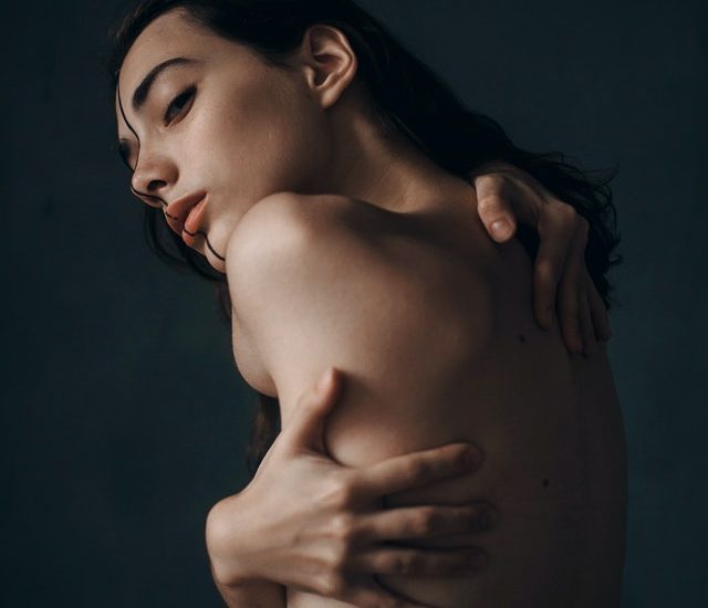 Woman hugging her naked body