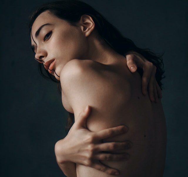 Woman hugging her naked body